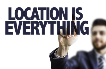 Business man pointing the text: Location is Everything