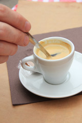 Man stiring an espresso