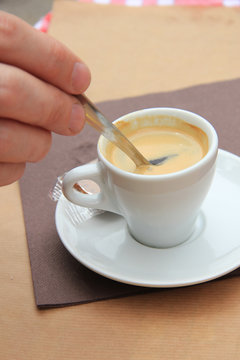 Man stiring an espresso