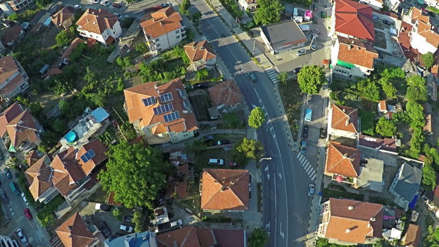 AERIAL Flight over suburban houses, yards and cars along suburban streets in countryside near to the sea coast with beach