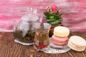 Fototapeta na wymiar exotic green tea with flowers in glass teapot