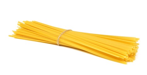 Uncooked dry fettuccine pasta tied in a bundle isolated on a white background