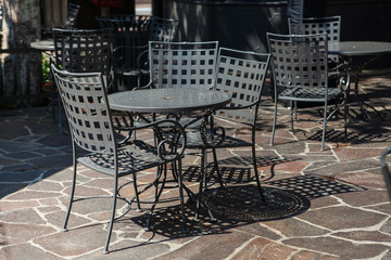 Tables and chairs set up for lunch outside cafe