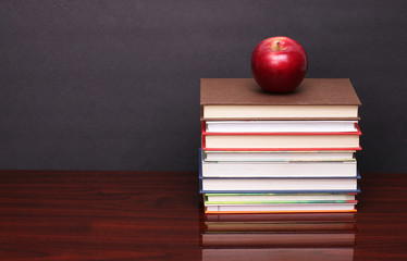 apple with books on wood table