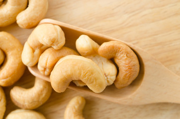 cashew nuts with salt in spoon wooden.