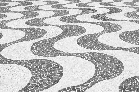Iconic black and white wave sidewalk tile pattern at Copacabana Beach Rio de Janeiro Brazil
