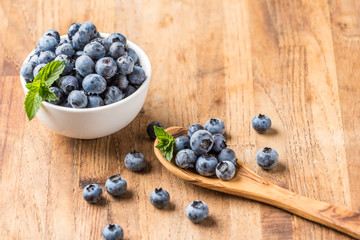 fresh blueberry on a wooden table and bowl