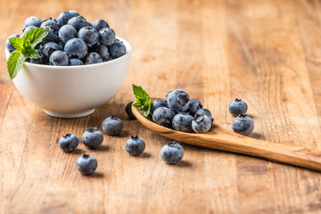 fresh blueberry on a wooden table and bowl