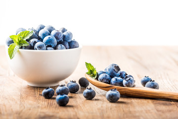 fresh blueberry on a wooden table and bowl