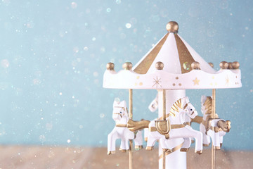 old vintage white carousel horses on wooden table   © tomertu