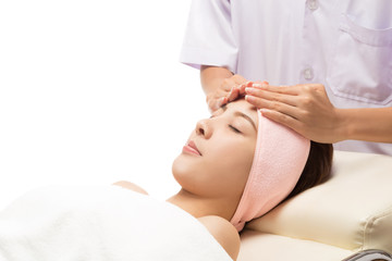Beauty and Spa - massage of face for woman in spa salon, enjoying a facial massage, isolated on white with clipping path.