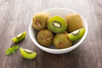 Fresh kiwis fruit on brown wooden background