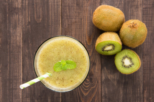 kiwi smoothie with fresh fruits on wooden background. Top view