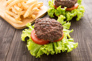 hamburger with french fries on wooden table