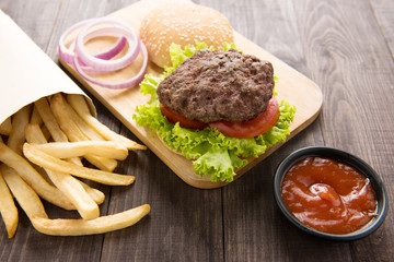 hamburger with french fries on wooden background