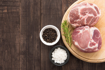 Top view raw fresh meat and garlic, pepper on wooden background