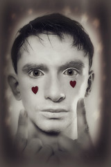 man with white makeup and red hearts on face
