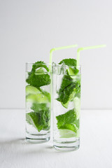 Mojito cocktail on the white wooden background