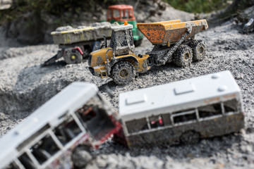 Fototapeta premium Forgotten toy cars. Forgotten toy cars in a sandbox, after rain.