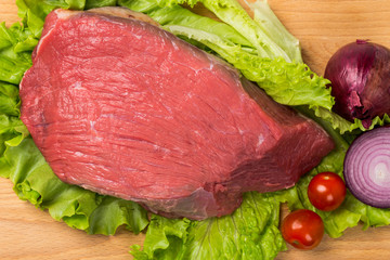 pice of fresh raw meat with vegetables