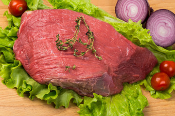 pice of fresh raw meat with vegetables