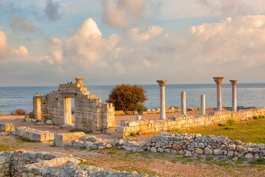 colonnade of the Ancient Greek city of Chersonese lit with the sun at sunrise, the Crimea