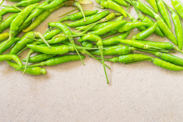 Green Chilli on wooden background