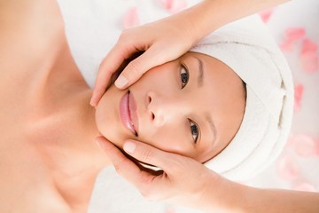 Fototapeta na wymiar Attractive young woman receiving facial massage 