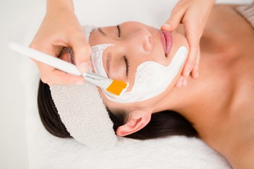 Naklejka premium Attractive woman receiving treatment at spa center