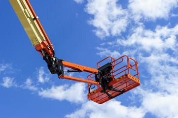 Cherry picker work bucket platform and hydraulic construction cradle of lifting arm painted in...