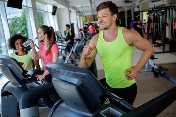 Man running on a treadmill in a gym