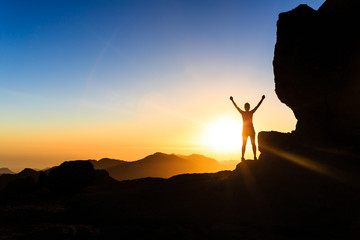 Woman climber success silhouette in mountains, ocean and sunset - 88918302