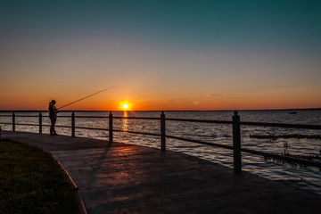 Fototapeta na wymiar fisherwoman at sunset