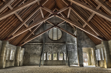 Fototapeta na wymiar Wide angle interior of old stone church with wood beams.