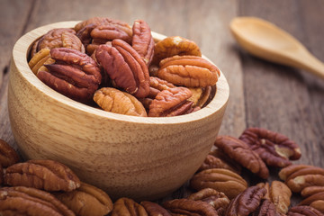 Pecan nuts in wooden bowl