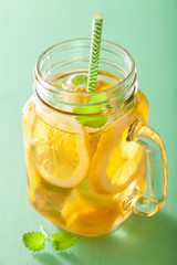ice tea with lemon and melissa in mason jar