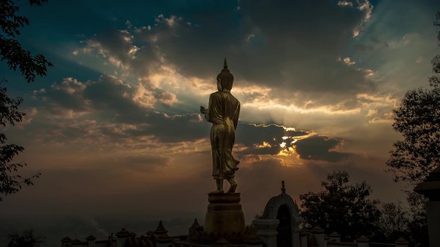HD Timelapse sunrise with golden buddha at Wat Phra That Kao Noi, that built during the 23rd-25th Buddhist centuries. Nan, THAILAND.