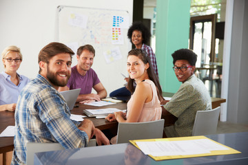Portrait Of Staff At Brainstorming Meeting In Office