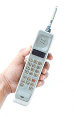 man hand holding vintage mobile phone Isolated on white background.