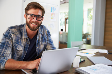 Portrait Of Businessman Working In Creative Office