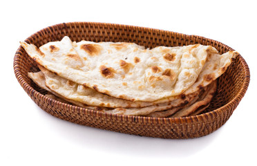 stack of indian naan bread in small basket