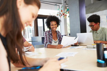 Three Businesspeople Having Creative Meeting In Office