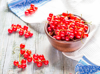 fresh red currants in brown clay piala,selective focus, rustic