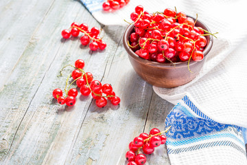 fresh red currants in brown clay piala,selective focus, rustic