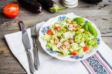 Fresh vegetable salad with tomato, eggplant, sesame seeds and fl