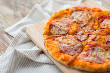close up of homemade pizza on wooden table