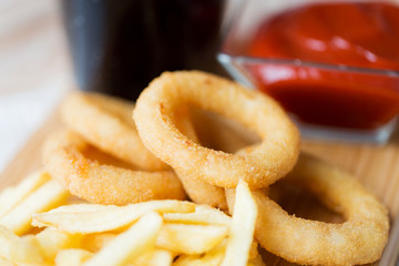 close up of fast food snacks and drink on table