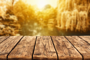 Naklejka na ściany i meble wooden table and autumn day 