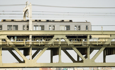 Side view of train over iron bridge
