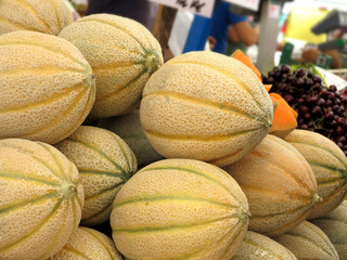 Market stall with many of melons and fruits. The light is great.